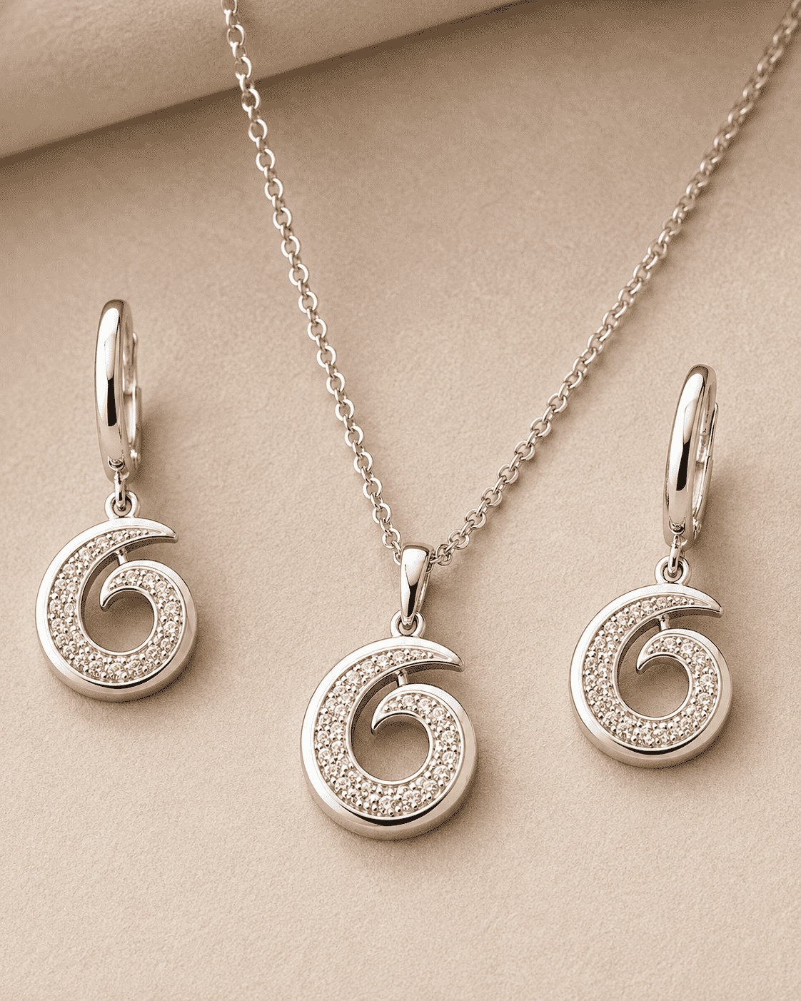 The Cinnamon Roll Spiral Set — Silver-Tone Spiral Pendant Set by House of Zena, styled on model