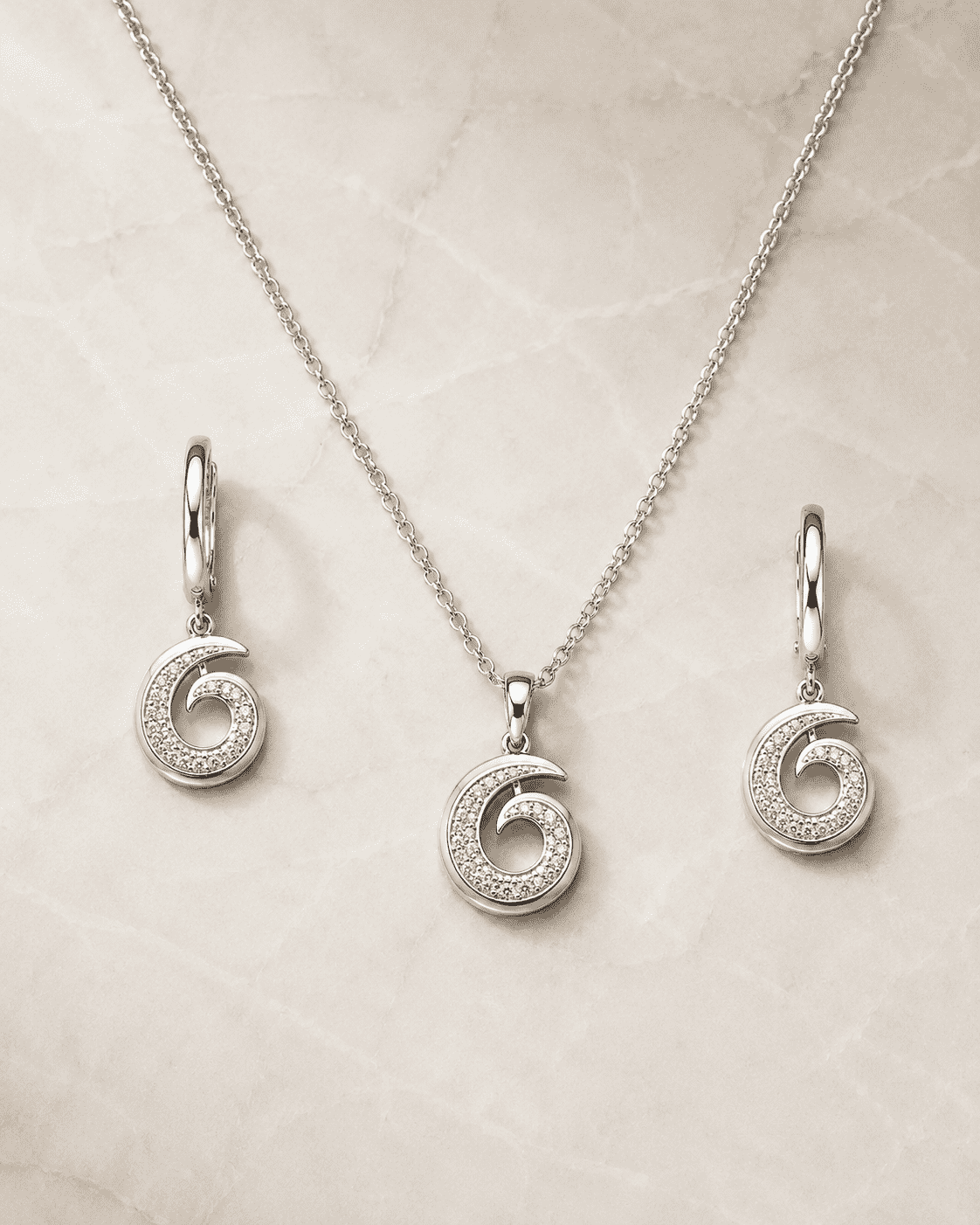 The Cinnamon Roll Spiral Set — Silver-Tone Spiral Pendant Set by House of Zena, worn on model