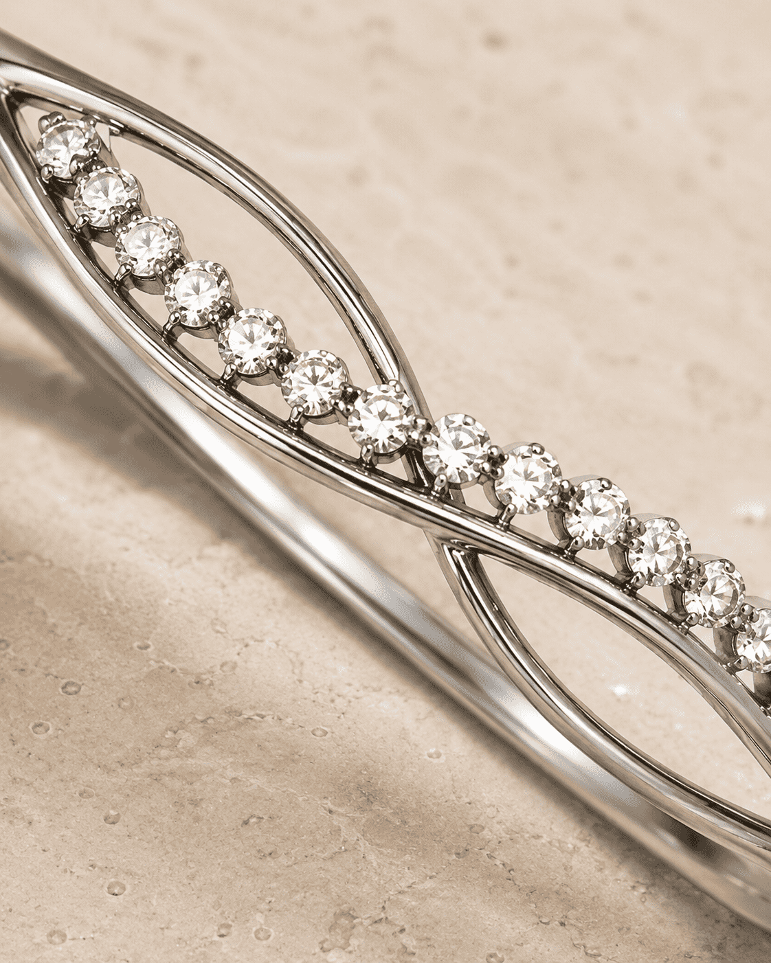 The "Forever Yours" Infinity Bangle — Silver-Tone Infinity Bangle by House of Zena, close-up detail