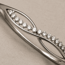 The "Forever Yours" Infinity Bangle — Silver-Tone Infinity Bangle by House of Zena, styled on model