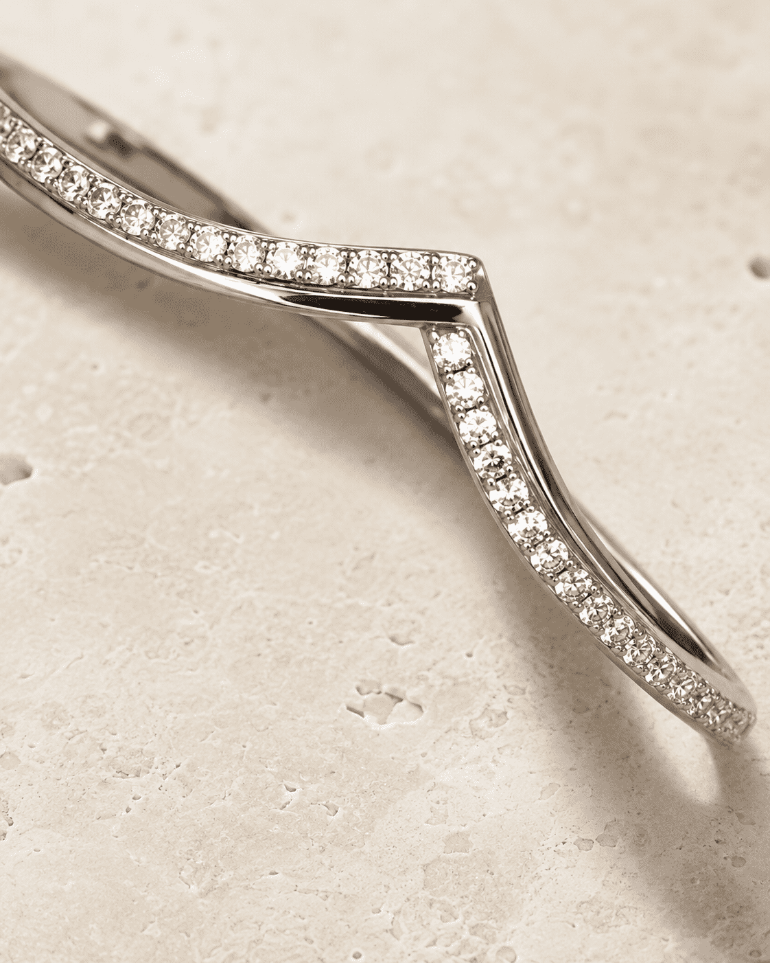 The "Kiss Me" Crisscross Bangle — Silver-Tone Twist Pavé Bangle by House of Zena, styled on model