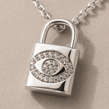The "Mind Your Business" Padlock — Silver-Tone Lock Evil Eye Necklace by House of Zena, styled on model