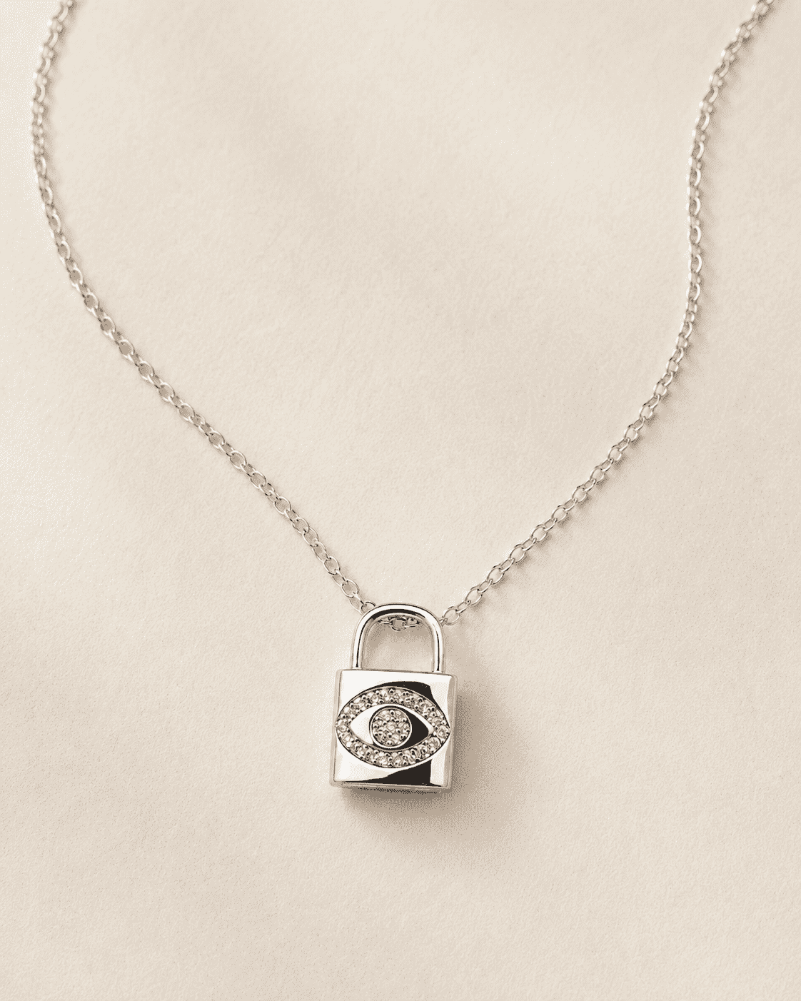 The "Mind Your Business" Padlock — Silver-Tone Lock Evil Eye Necklace by House of Zena, worn on model