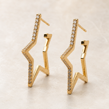 The Lucky Star Outline Hoops — Gold Plated Star Outline Hoop Earrings by House of Zena, styled on model