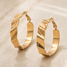 The Riviera Wave Sculpted Hoops — Gold Plated Wave Hoop Earrings by House of Zena, styled on model