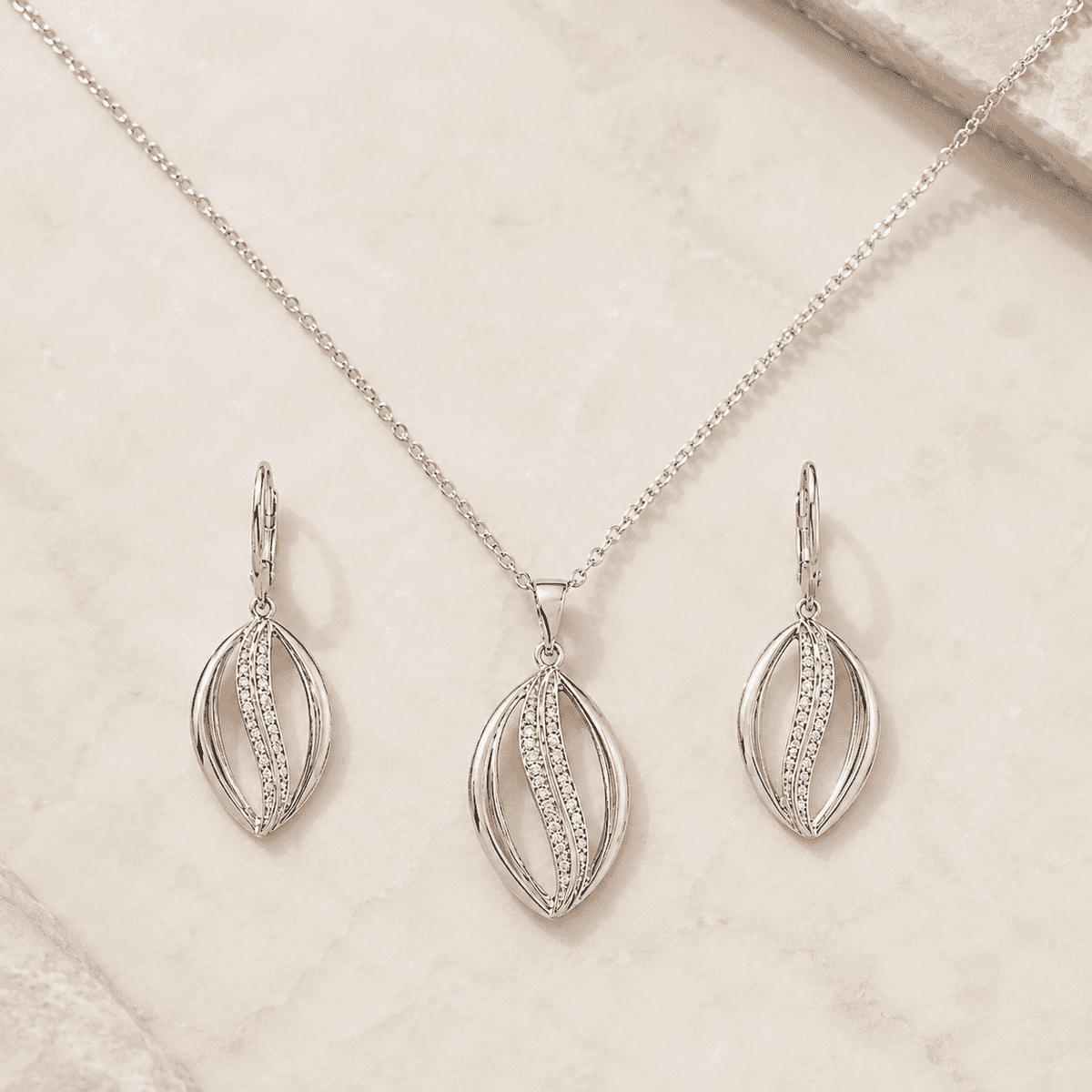 The Melted Honeycomb Set — Gold Plated Wave Pendant Set by House of Zena, worn on model