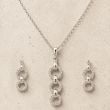 The "You & Me" Interlock Set — Silver-Tone Link Pendant Set by House of Zena, worn on model