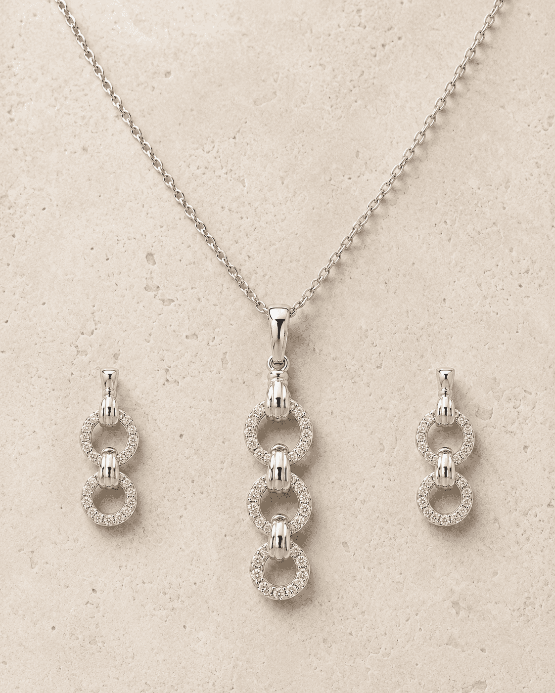 The "You & Me" Interlock Set — Silver-Tone Link Pendant Set by House of Zena, worn on model