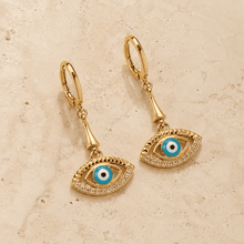 The Side-Eye Charm Drops — Gold Plated Evil Eye Drop Earrings by House of Zena, side angle