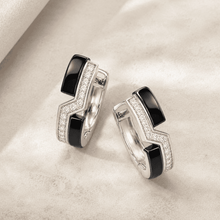 The Black Sesame Crescent Hoops — Silver-Tone Curve Hoop Earrings by House of Zena, styled on model