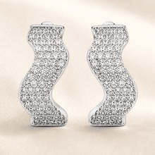 The Ocean Ripple Huggies — Silver-Tone Wave Huggie Earrings by House of Zena, worn on model