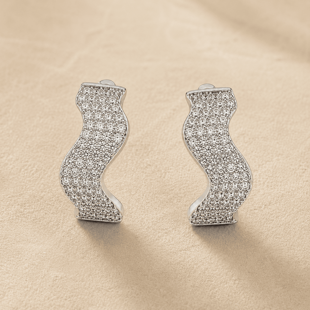 The Ocean Ripple Huggies — Silver-Tone Wave Huggie Earrings by House of Zena, styled on model — Anti-Tarnish Waterproof Jewellery | House of Zena