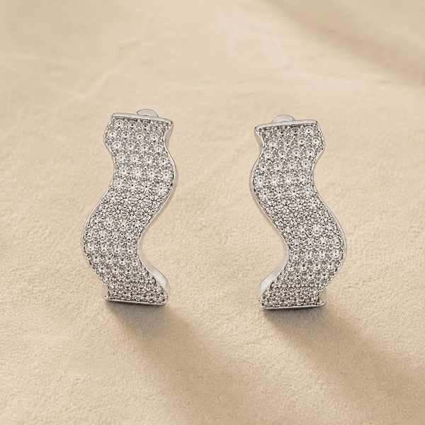 The Ocean Ripple Huggies — Silver-Tone Wave Huggie Earrings by House of Zena, styled on model — Anti-Tarnish Waterproof Jewellery | House of Zena