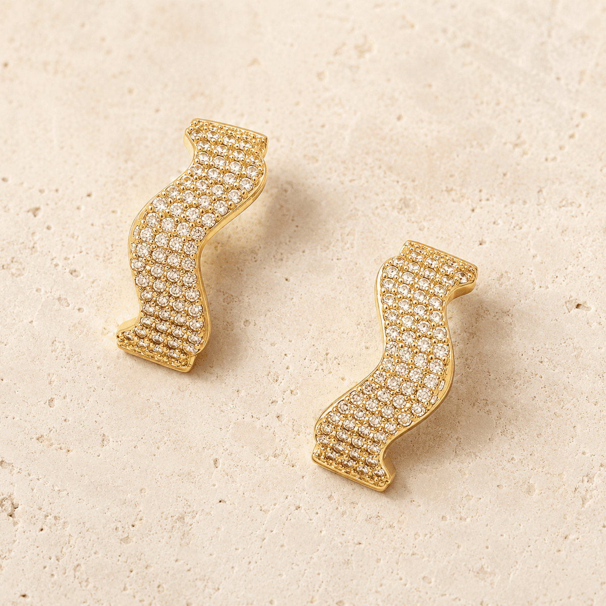 The Golden Nugget Huggies — Gold Plated Wave Crystal Huggie Earrings by House of Zena, worn on model