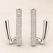 The Crisscross Pavé Illusion Hoops — Silver-Tone Dual Curve Pavé Hoop Earrings by House of Zena, styled on model