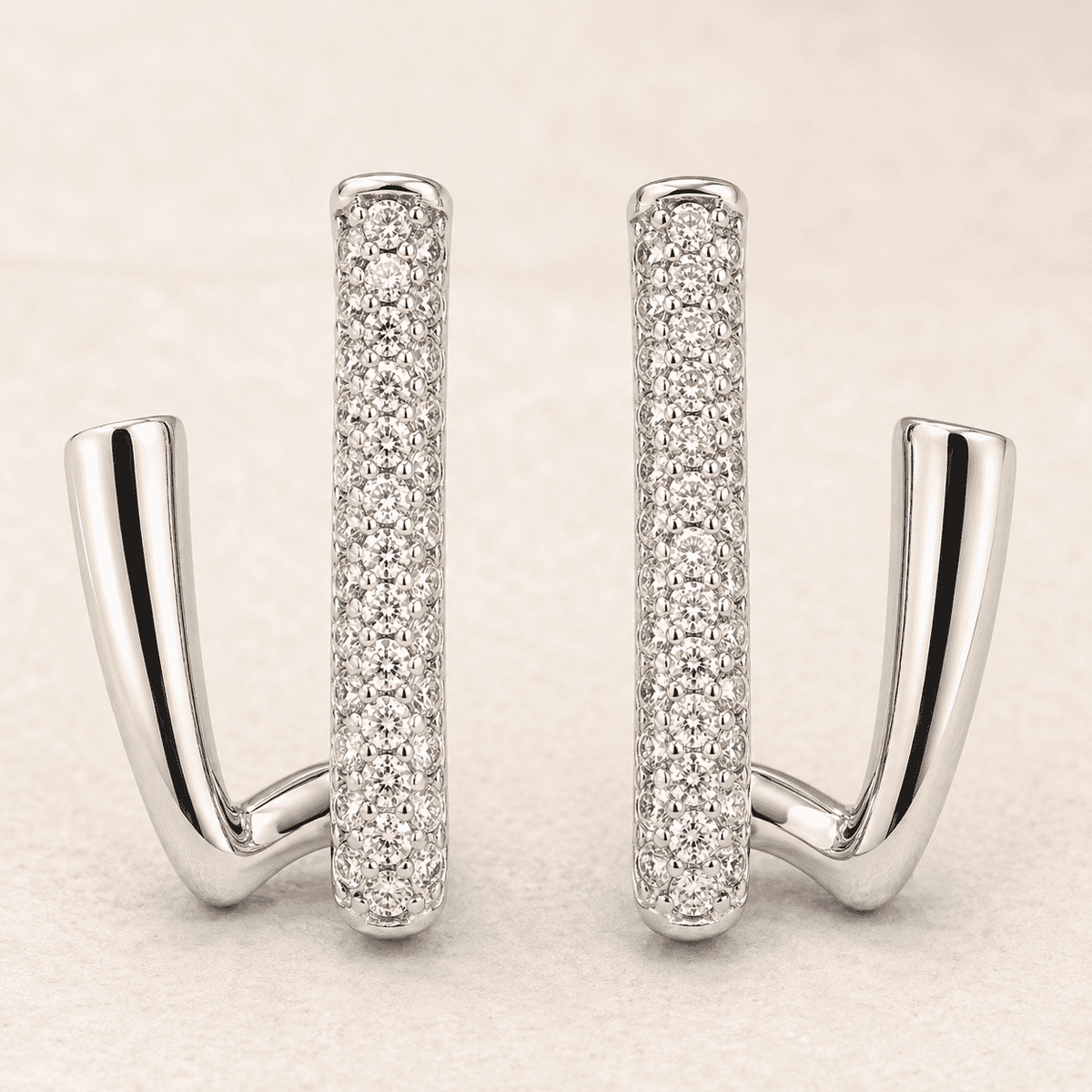 The Crisscross Pavé Illusion Hoops — Silver-Tone Dual Curve Pavé Hoop Earrings by House of Zena, styled on model
