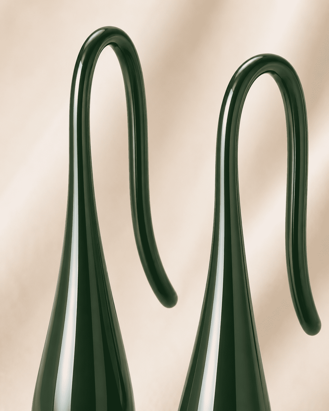The Green Apple Mini Huggies — Gold Plated Emerald Drop Huggie Earrings by House of Zena, styled on model