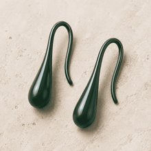 The Green Apple Mini Huggies — Gold Plated Emerald Drop Huggie Earrings by House of Zena, worn on model