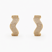 The Golden Nugget Huggies — Gold Plated Wave Crystal Huggie Earrings by House of Zena, flat lay