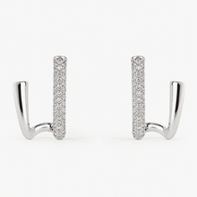 The Crisscross Pavé Illusion Hoops — Silver-Tone Dual Curve Pavé Hoop Earrings by House of Zena, worn on model
