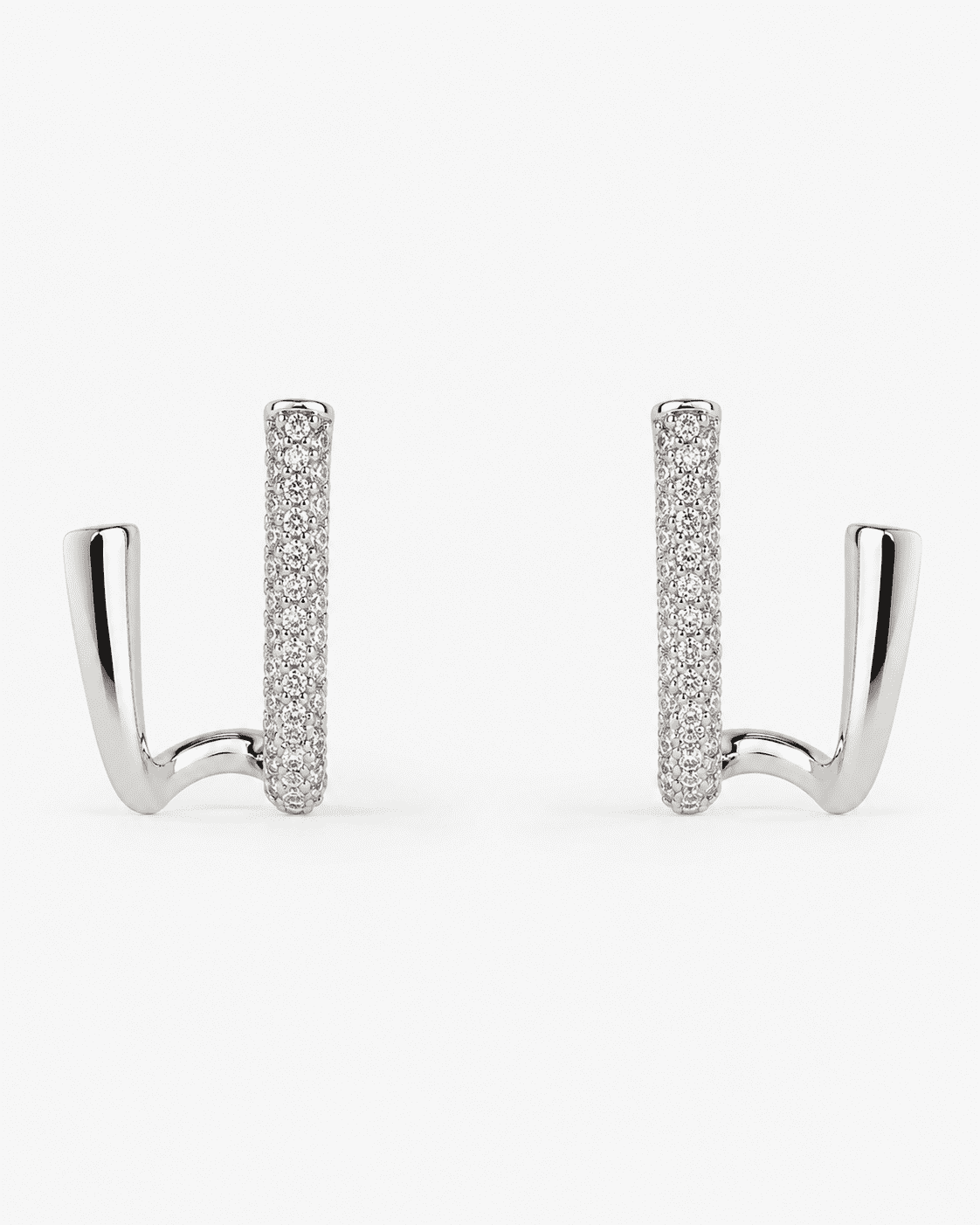 The Crisscross Pavé Illusion Hoops — Silver-Tone Dual Curve Pavé Hoop Earrings by House of Zena, worn on model
