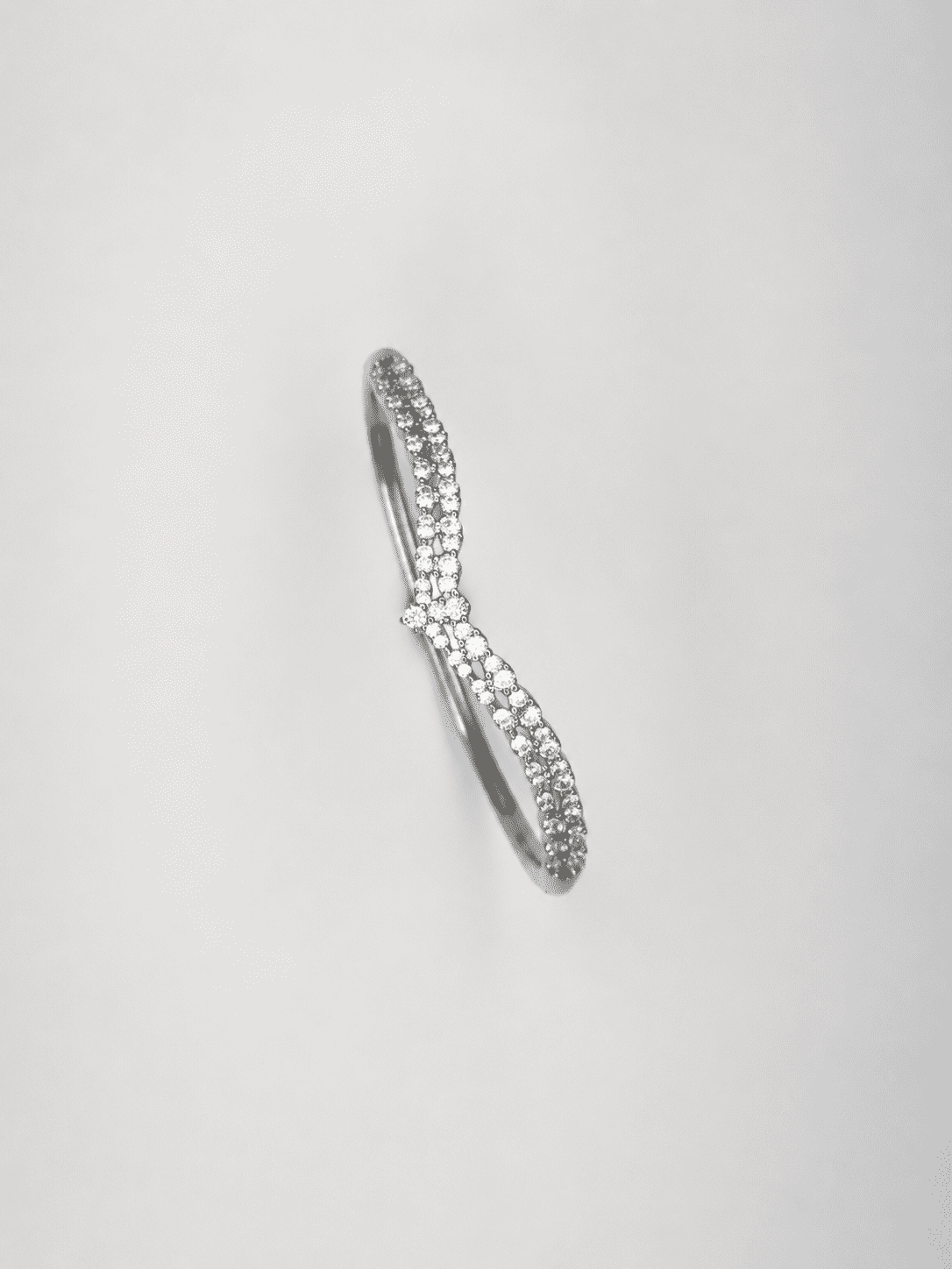 The Croissant Tennis Bangle — Silver-Tone Twist Tennis Bangle by House of Zena, side angle