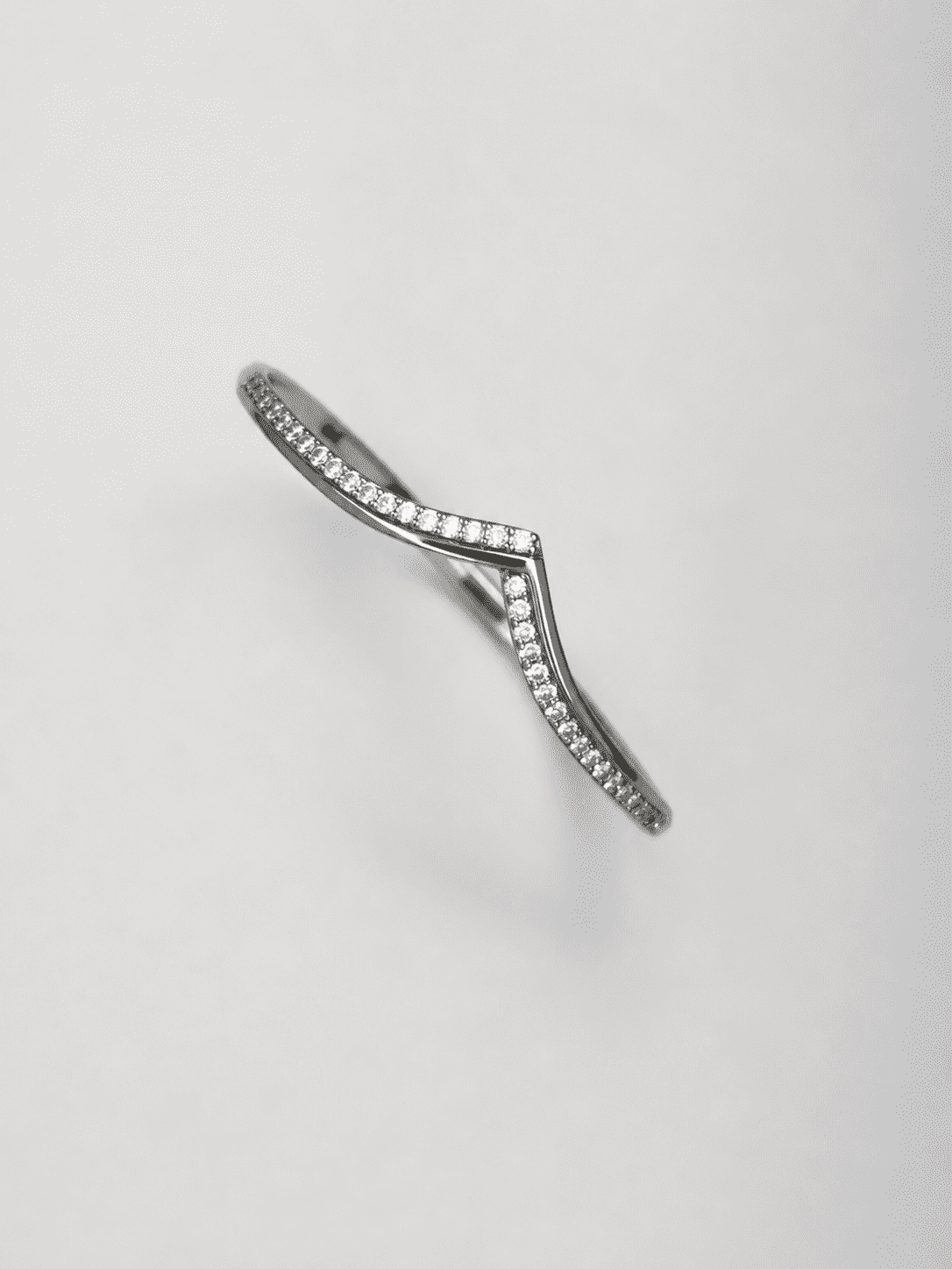 The "Kiss Me" Crisscross Bangle — Silver-Tone Twist Pavé Bangle by House of Zena, worn on model