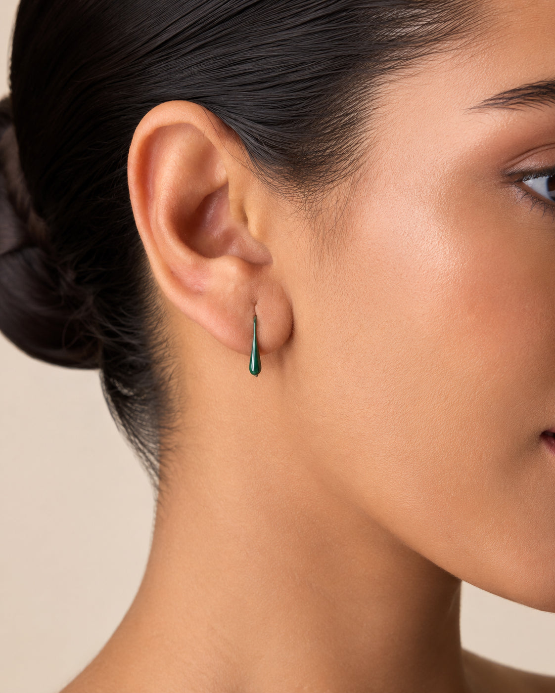 The Green Apple Mini Huggies — Gold Plated Emerald Drop Huggie Earrings by House of Zena, styled on model